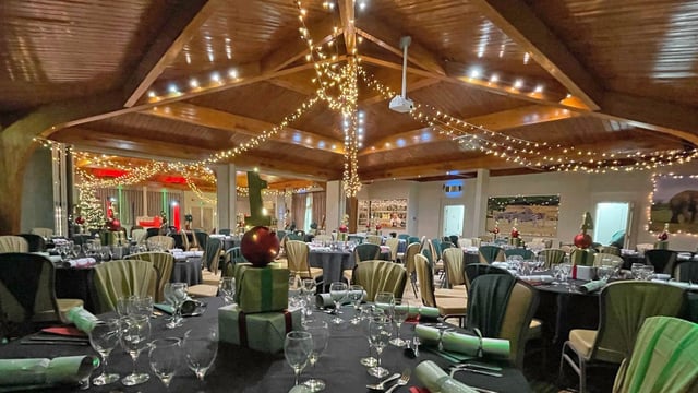 Christmas party set up in The Safari Lodge, showing table decorations and Christmas tree 